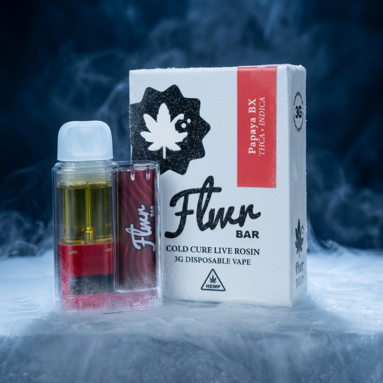 Flwr Bar disposable vape and its packaging box on a smoky blue background. The box is white with a red vertical stripe and black text, and the vape device is in a clear case showing yellow oil and red accents.